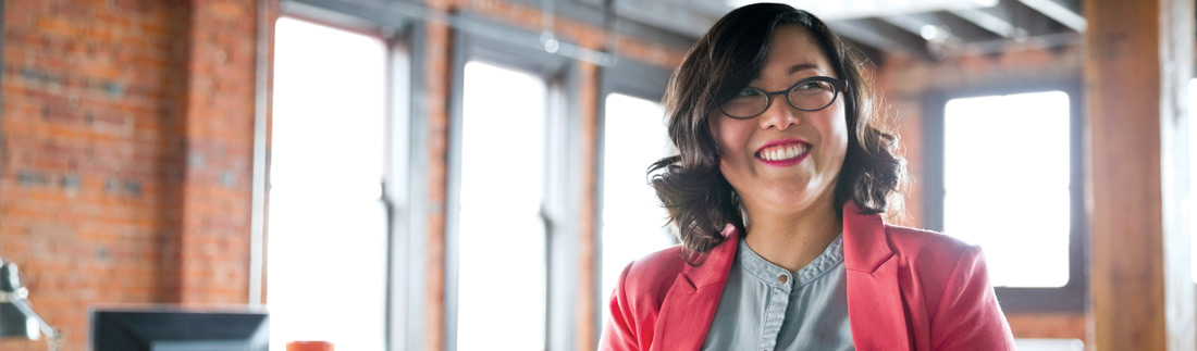 Smiling young business woman in her office.